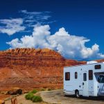An RV parked in the canyon on a road trip. .