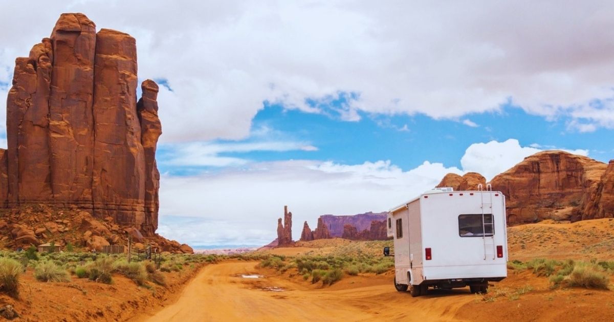 An RV Motorhome on the road in the hot Monument Valley in Utah